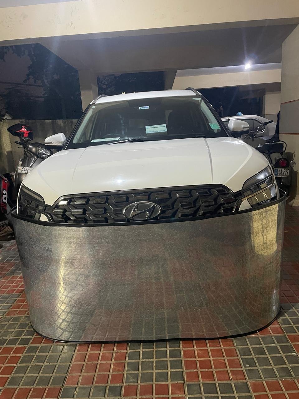 Car-lungi anti-rat steel skirt on white Audi A4 in indoor garage - premium car rat protection
